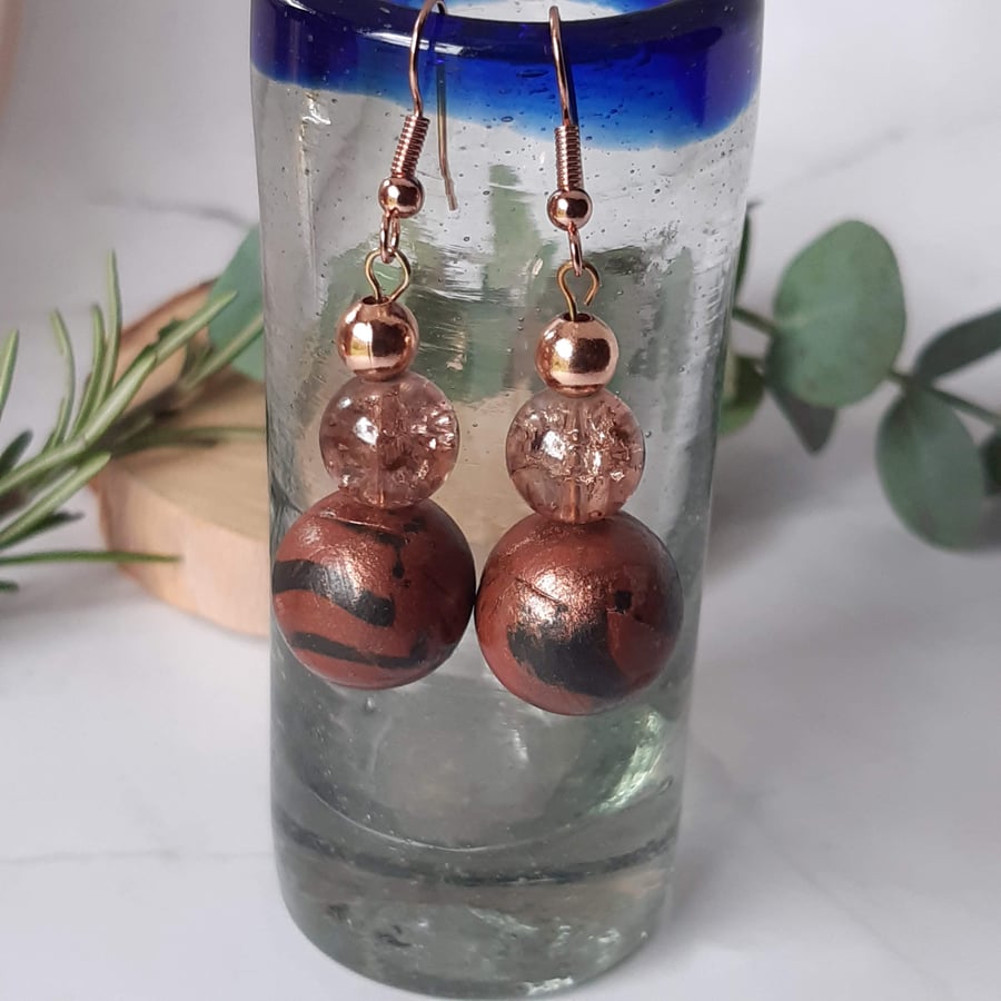 Conker brown and black dangly earrings with a bronze sheen