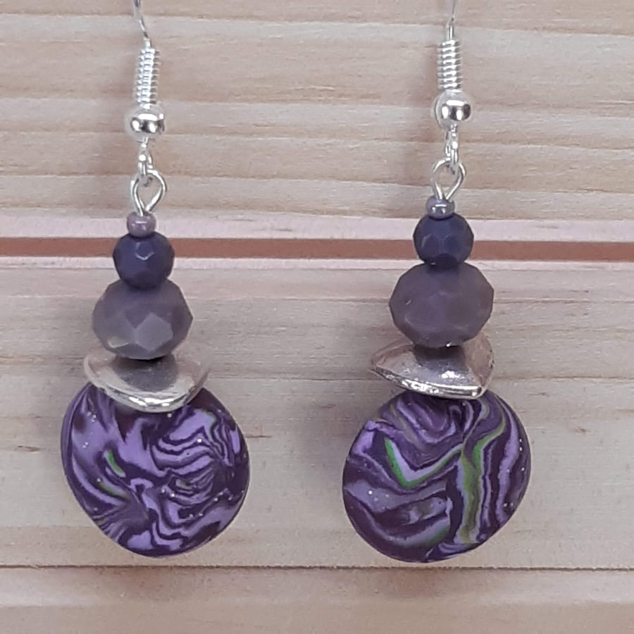 Dangly polymer clay earrings in a purple swirl design
