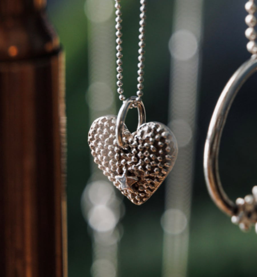 Silver twinkly heart pendant with a shining star