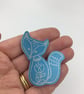 Anodised aluminium silver fox brooch on turquoise background - Image 2