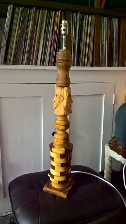 A table lamp with Hand carved faces and eclectic phases, 720 mm tall