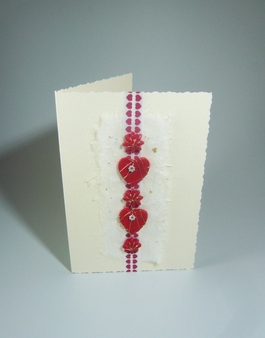 Handmade Valentine's Card. Hearts and flowers with flower beads and ribbon.