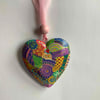 Pink ribbon with shimmering wooden heart