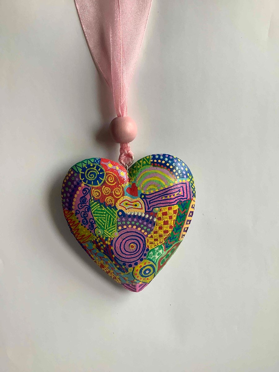 Pink ribbon with shimmering wooden heart