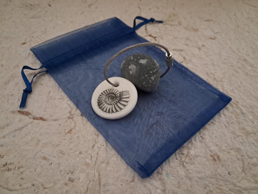Pebble keyring with an ammonite fossil image