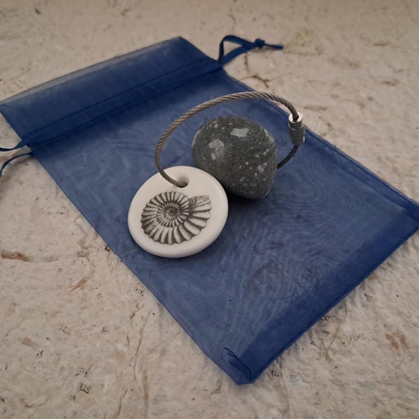 Pebble keyring with an ammonite fossil image