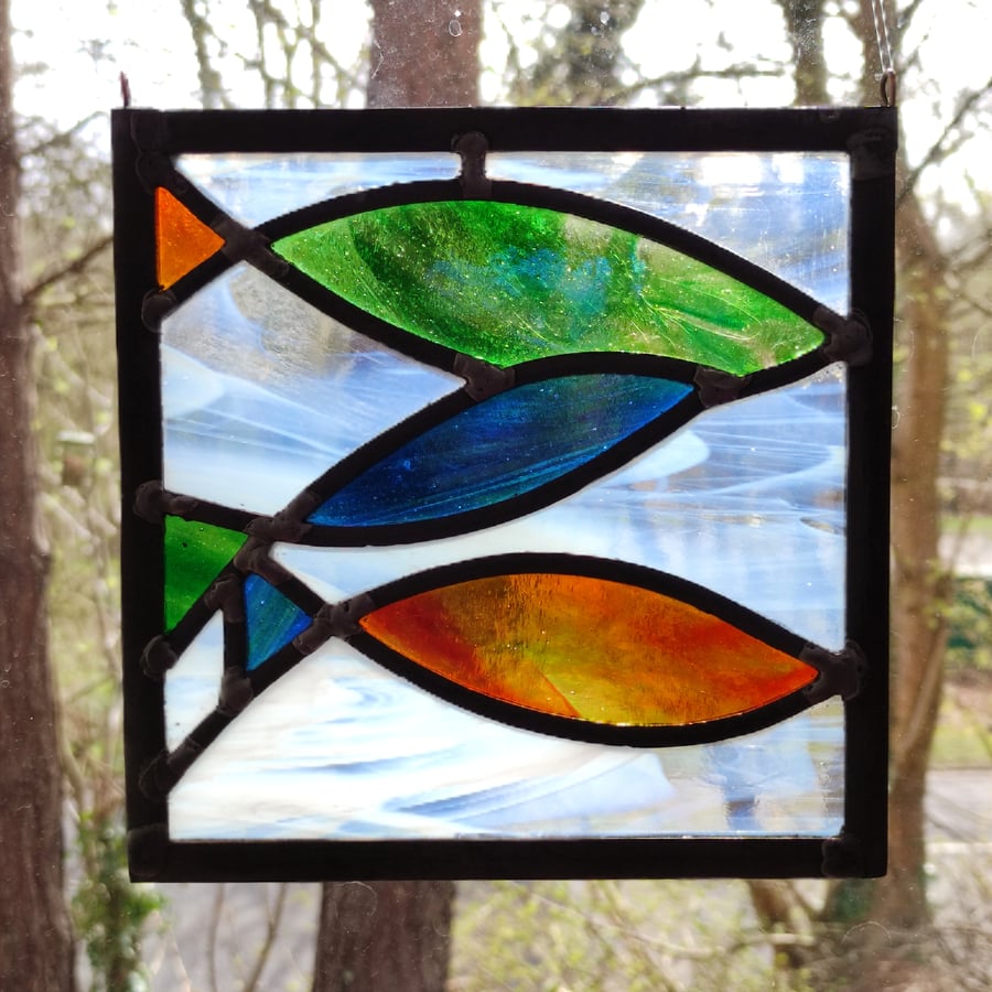 Stained glass three fishes in blue, orange and green leaded panel 