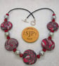 Disc shaped necklace in a red, black and silver swirl design - Image 3