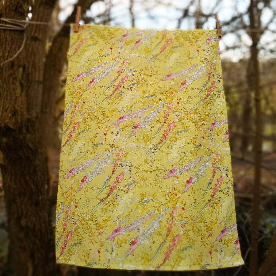 Yellow floral design tea towel with hanging loop