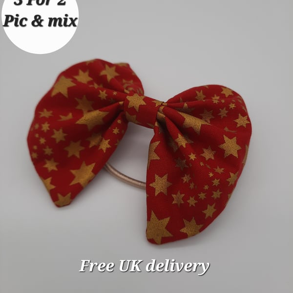 Hair bow bobble red with gold stars. 