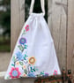 Embroidered linen drawstring bag with gingham back