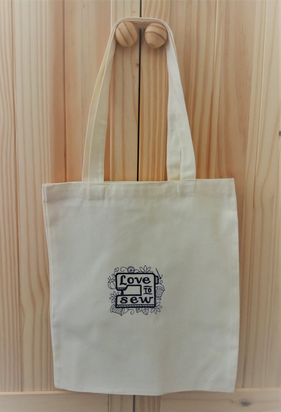 Cream cotton tote bag machine embroider with the words love to sew