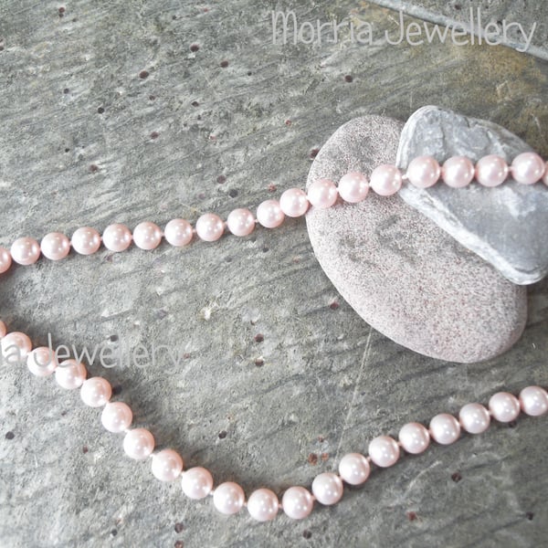 Pearl necklace with heart toggle clasp.