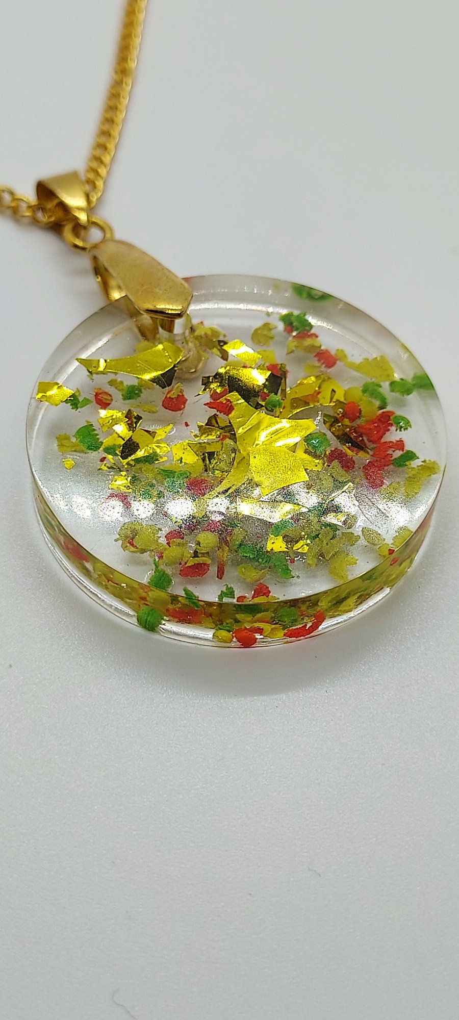 Fun resin pendant necklace with wax crayon flakes. 