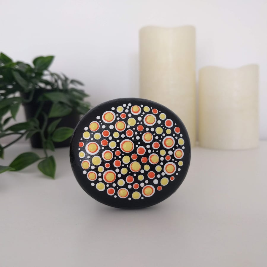 Yellow and orange dot painted wooden pebble