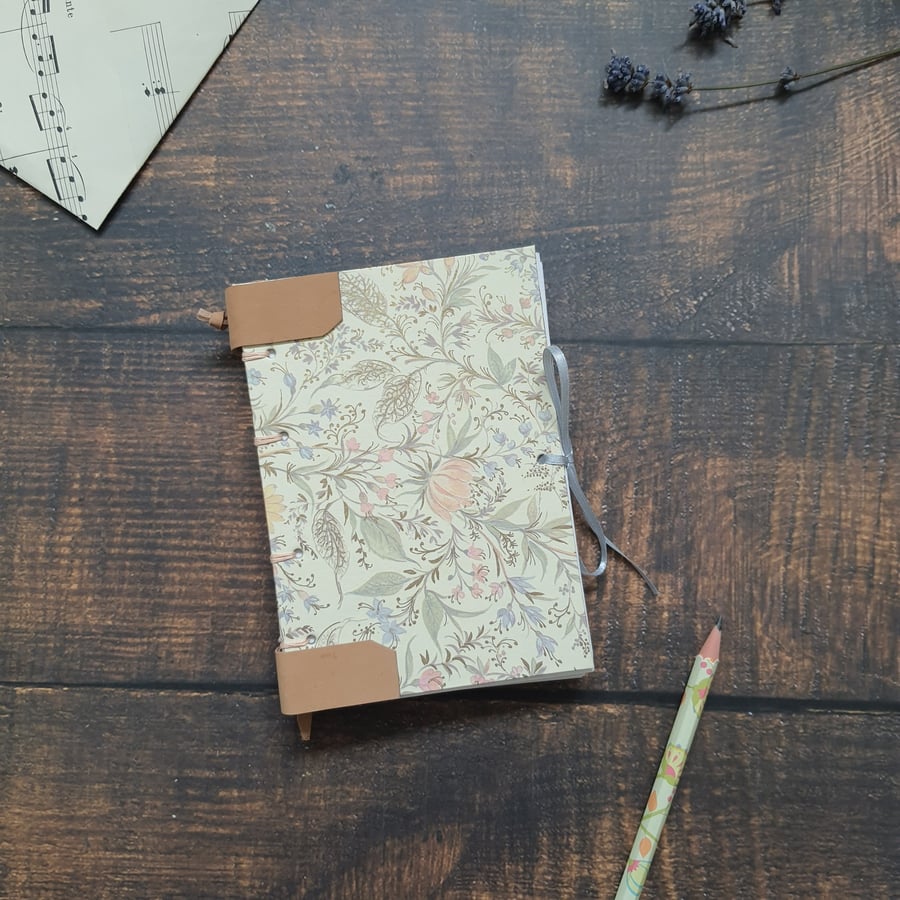 Handmade floral A6 journal, with Coptic stitching and leather detail