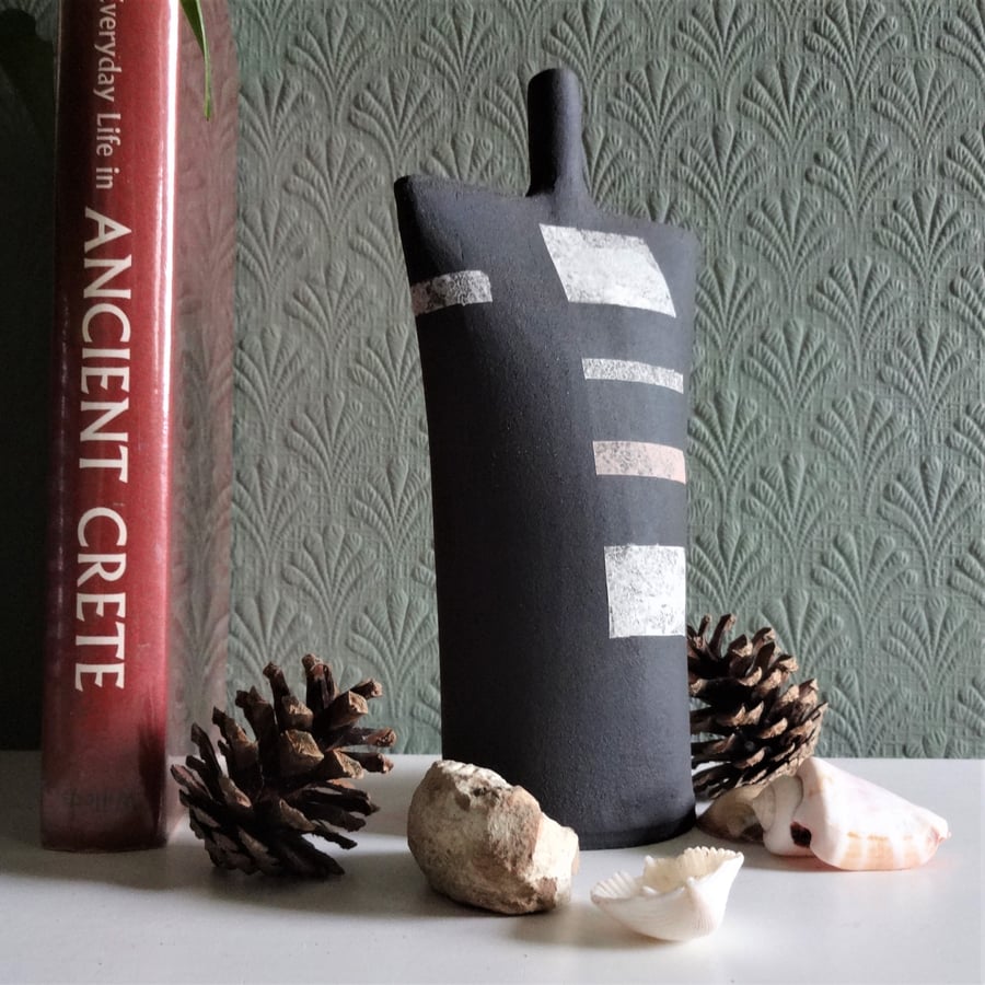 Minimalist abstract ceramic, black stoneware with cool, calm decorative motifs.