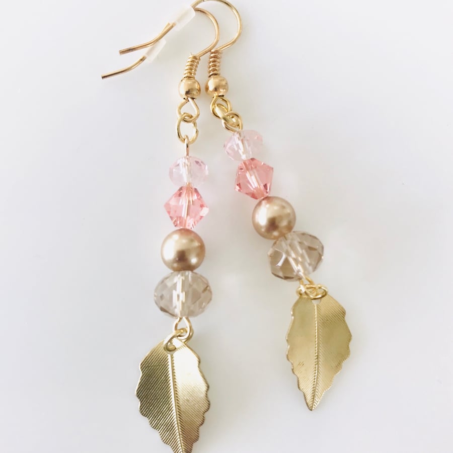 Pale pink and gold earrings with golden leaves