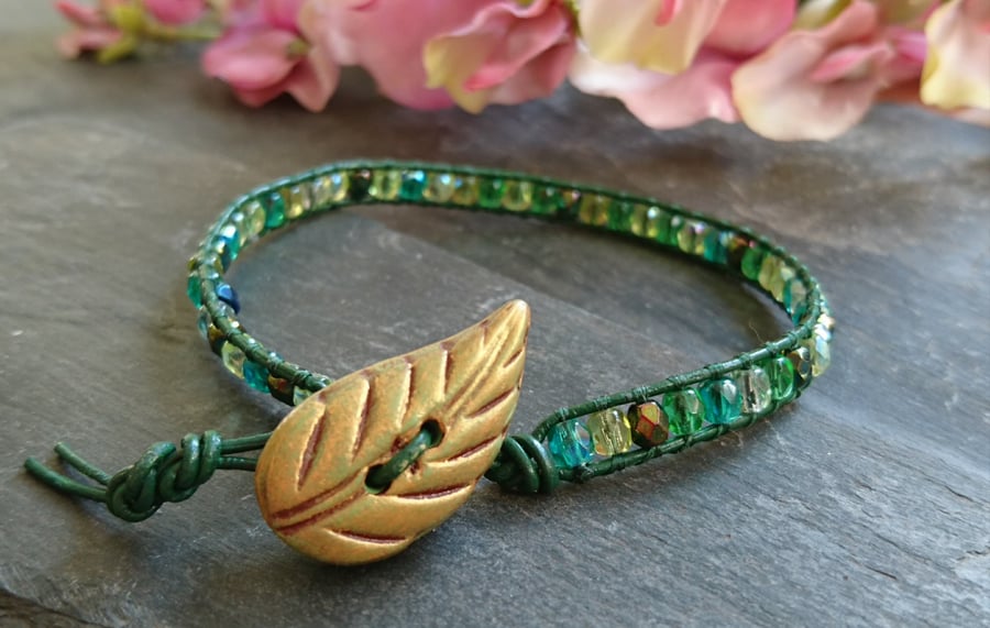 Leather bracelet with green glass beads and gold leaf button