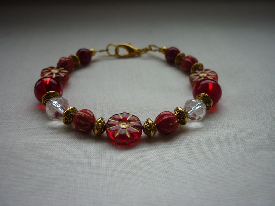 RED, CRYSTAL AND GOLD BRACELET.  1086