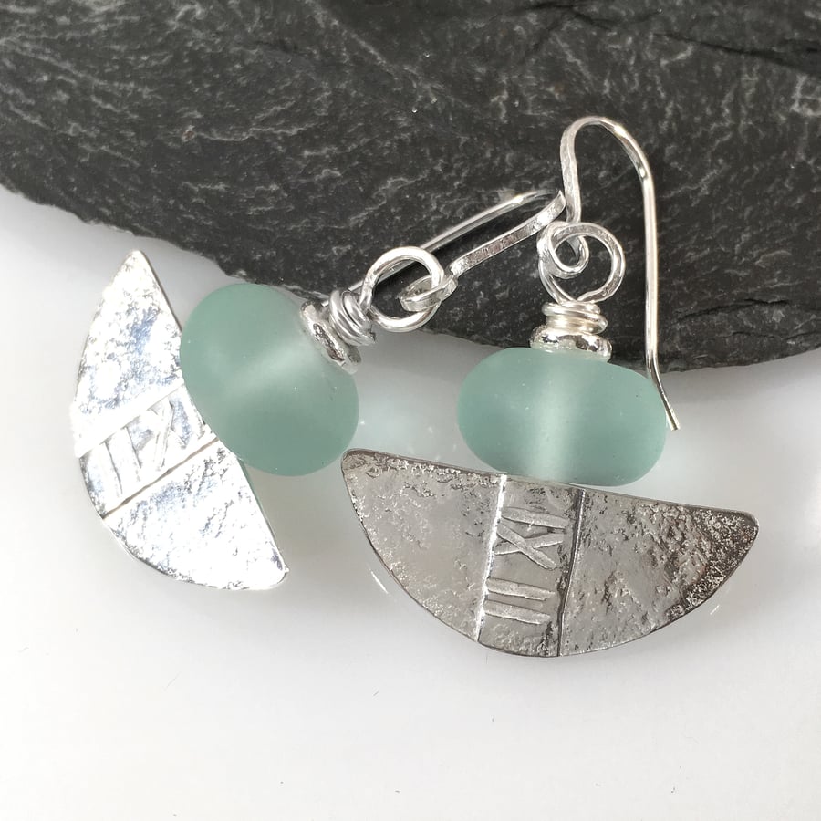 Silver and aqua glass tribal blade earrings.