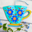 Wooden teacup hanging with blue green flowers for cottage core kitchen décor 