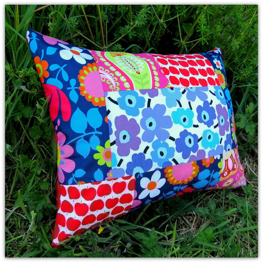 A vibrant patchwork cushion, with inner pad. Folksy