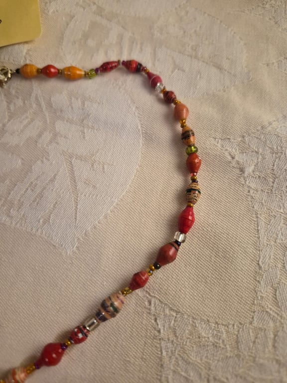Vibrant multi-hued orange paper and glass beaded necklace