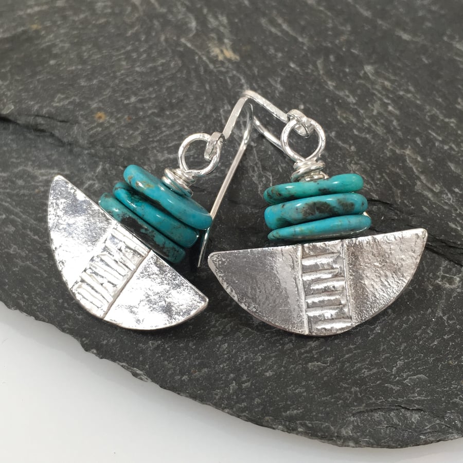 Silver and turquoise tribal blade earrings.