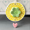 Pottery flower decoration with dangly heart 