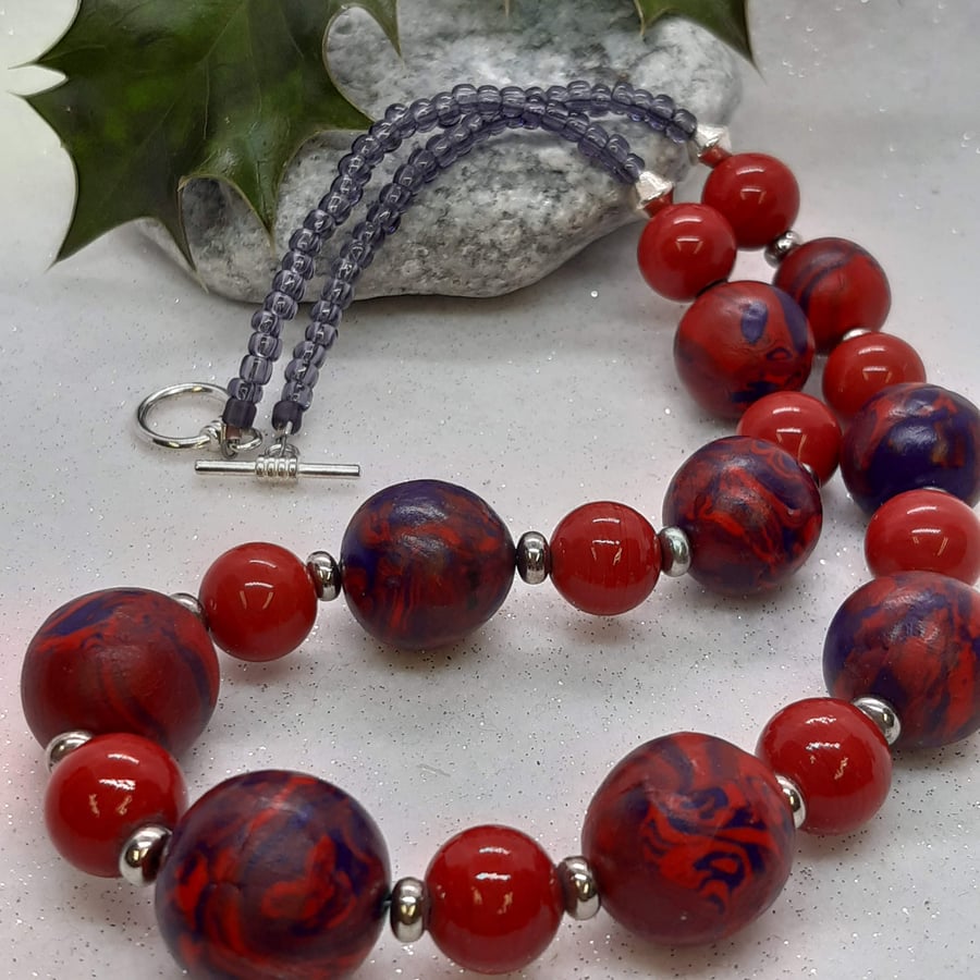Necklace in a poppy red and purple swirl design