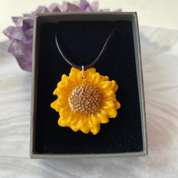 Sunflower statement pendant on a black cord necklace hand painted polymer clay.
