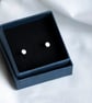 Silver cylindrical ear studs with a brush matte texture - Image 3