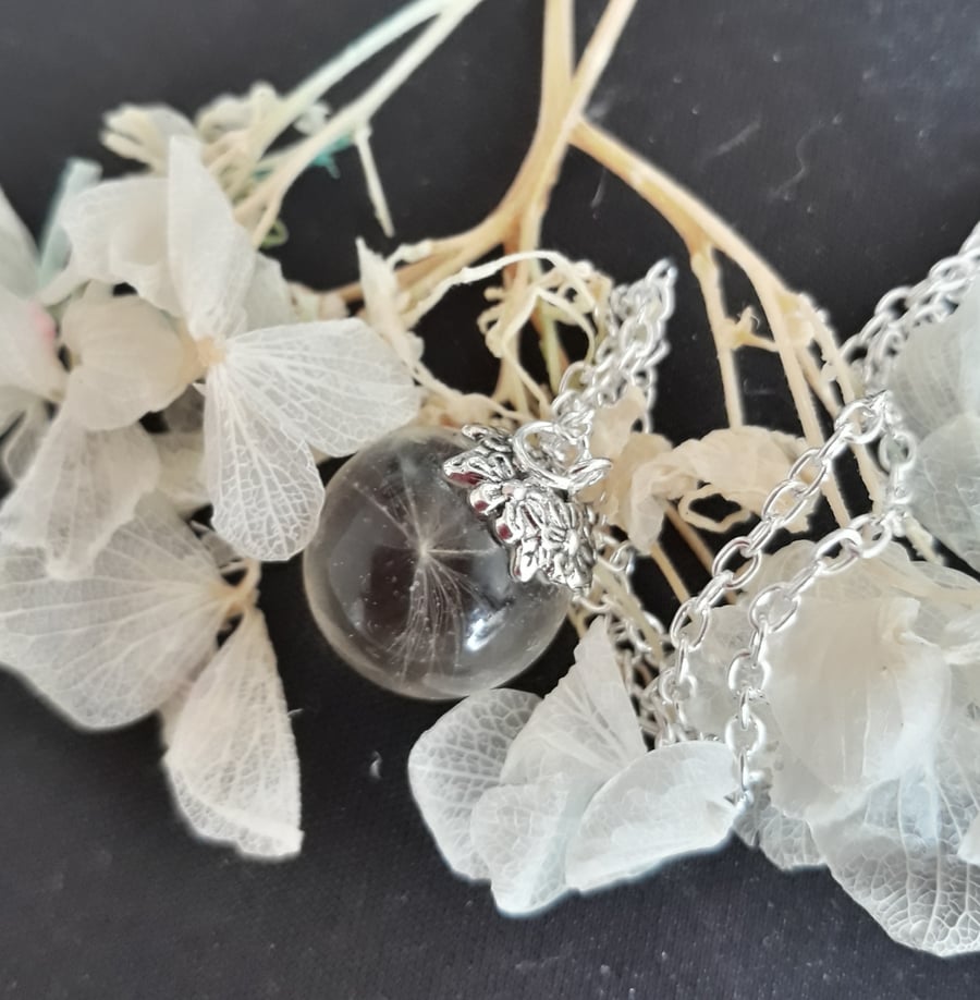 R12. Resin globe necklace with dandelion seed.