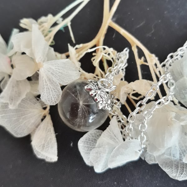 R12. Resin globe necklace with dandelion seed.
