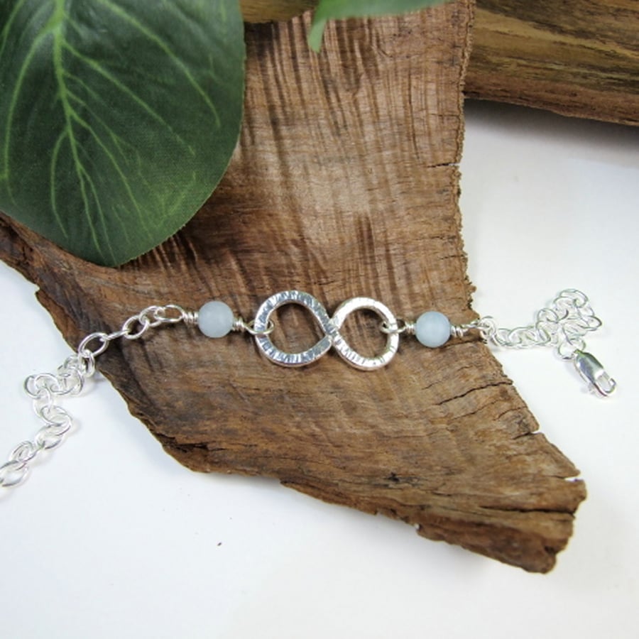 Sterling Silver Infinity Knot Bracelet with Aquamarine. Adjustable Fit