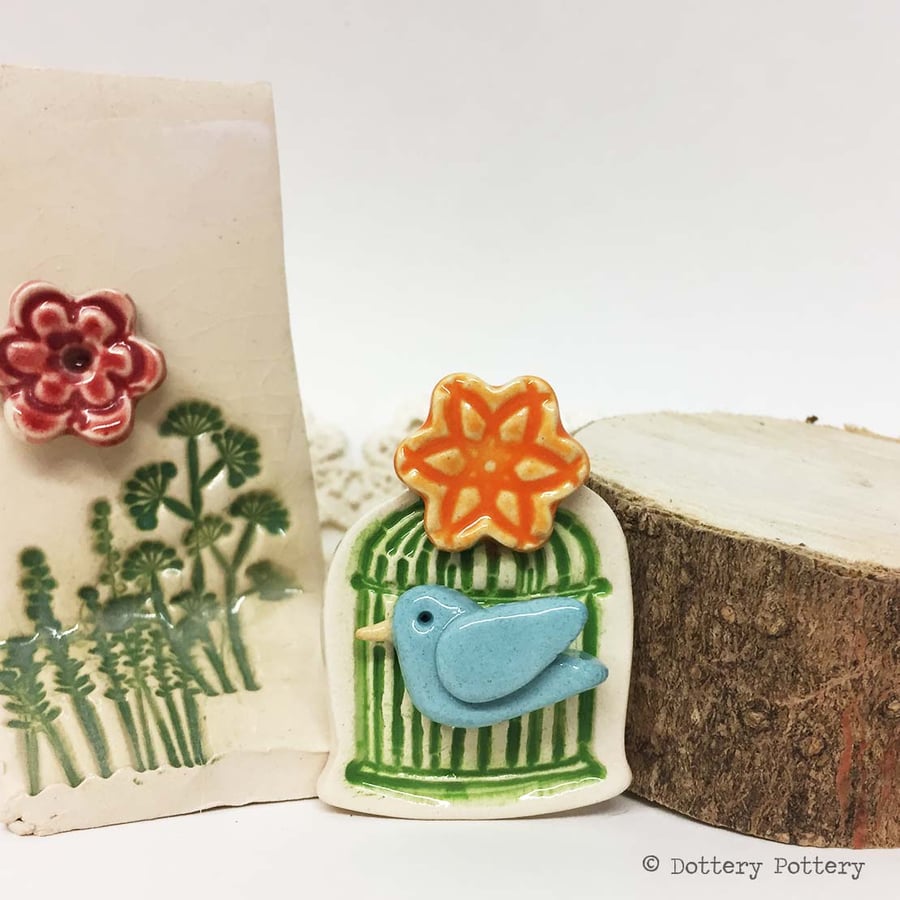 Little ceramic bird cage brooch with flower. Pottery jewellery