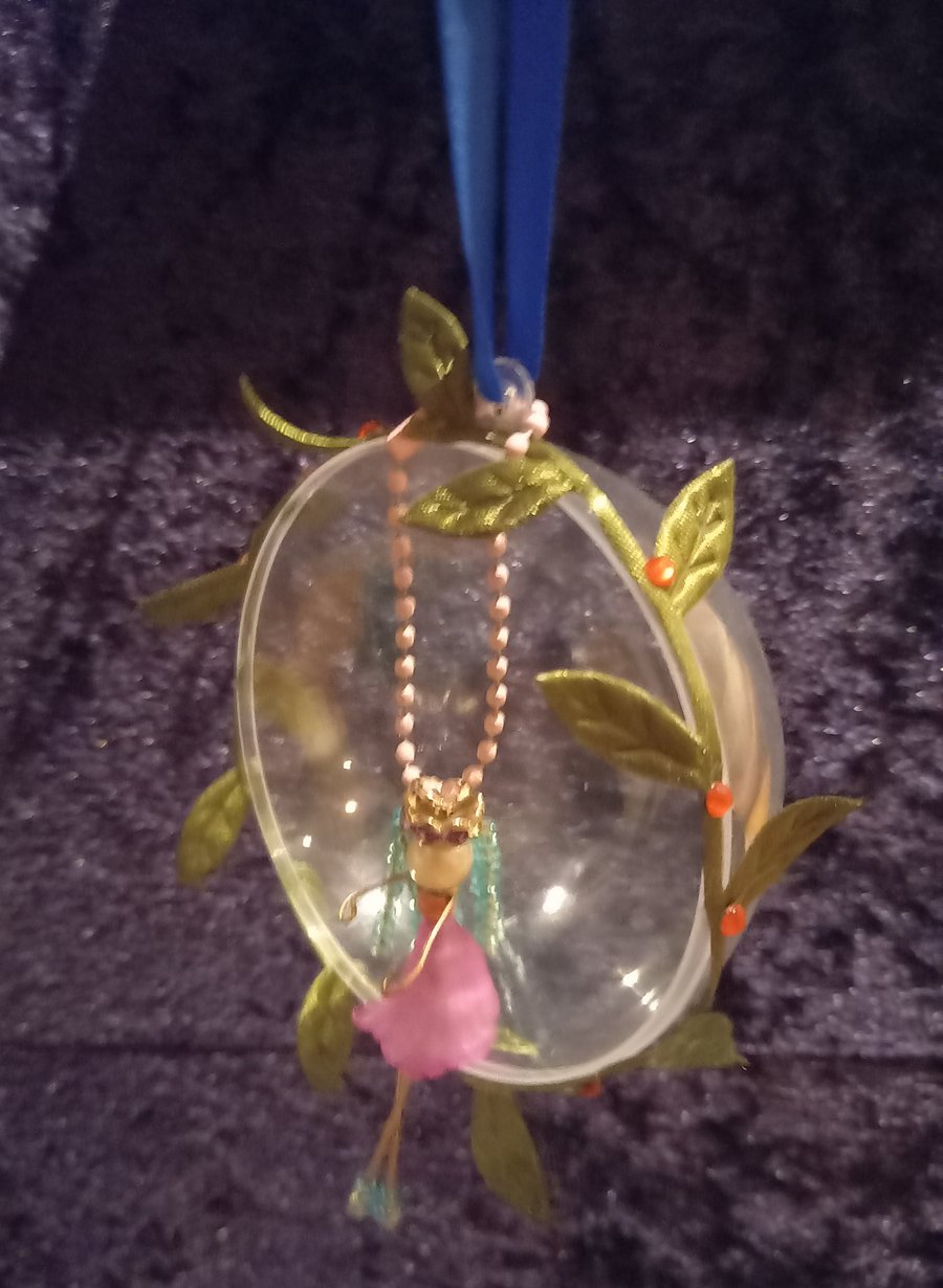 Little lady sitting within a bauble