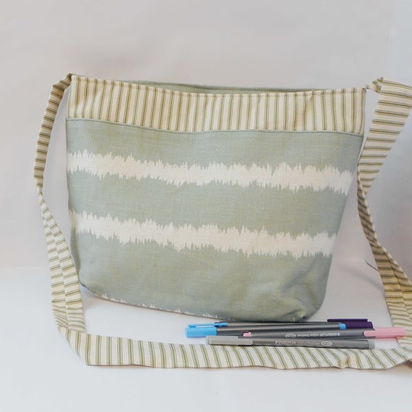 Soft green and white striped fabric shoulder bag