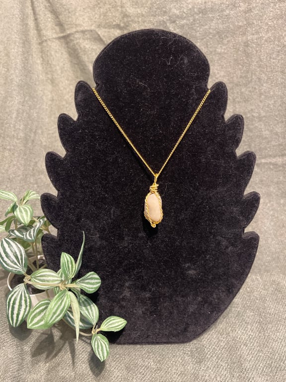Beautiful wire wrapped pebble pendant on gold coloured chain. 