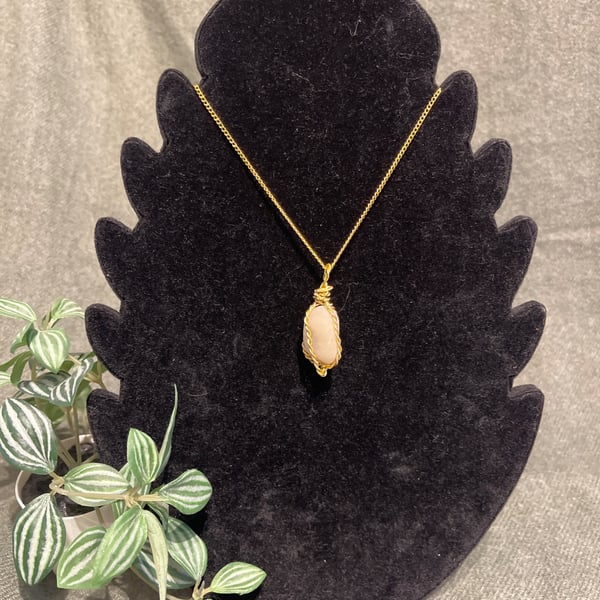 Beautiful wire wrapped pebble pendant on gold coloured chain. 