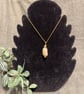 Beautiful wire wrapped pebble pendant on gold coloured chain. 