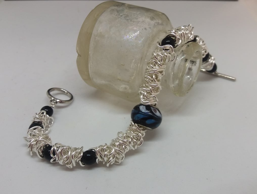 BR186  Scrunched chain link bracelet with black beads.