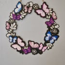 Wooden flower and butterfly wreath. 