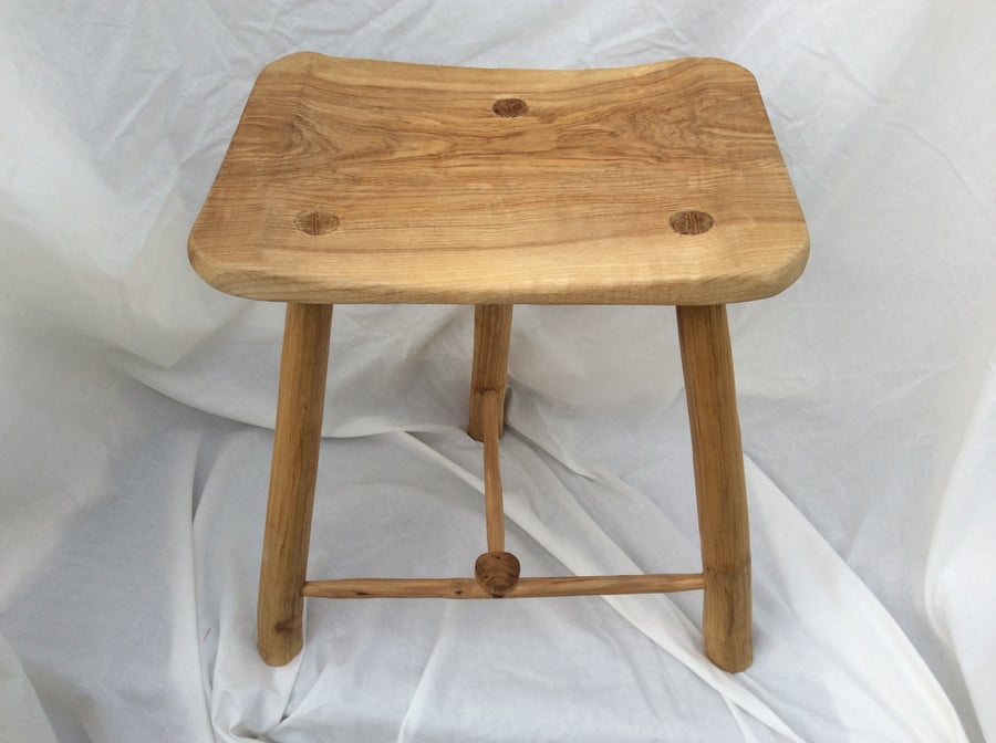  Three-legged stool with a rectangular seat