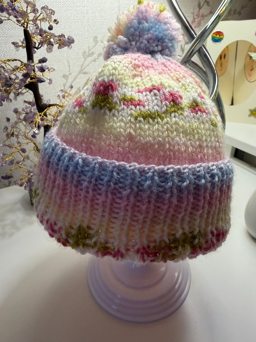 Hand knitted baby hat with rib and  Pom Pom.