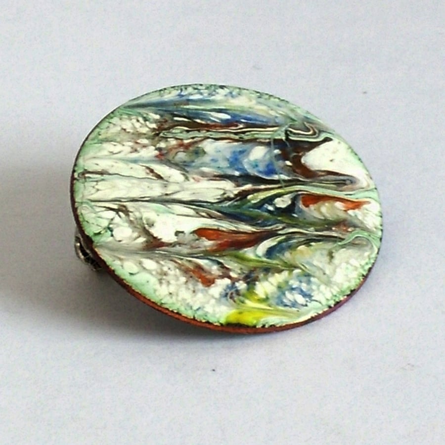 medium round brooch - scrolled red, yellow, black, blue on white