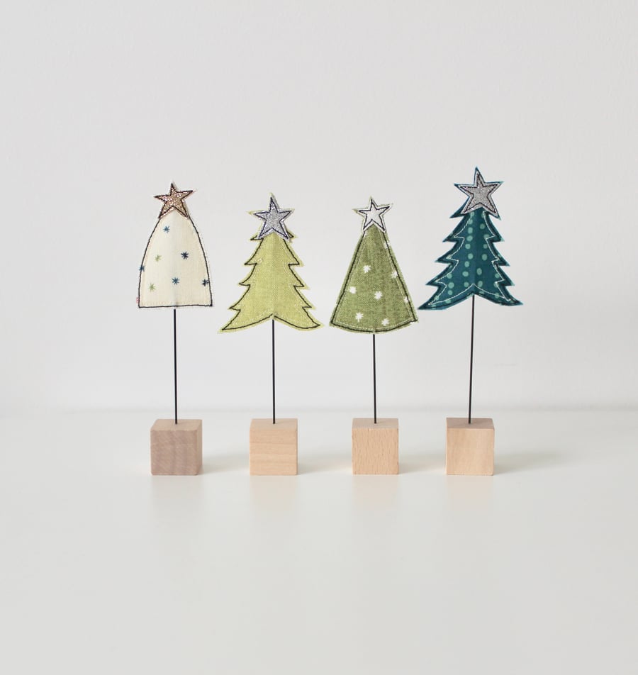 A Christmas Tree with a Wire Stem and Wooden Block Stand