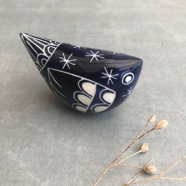 Small dark blue ceramic bird .