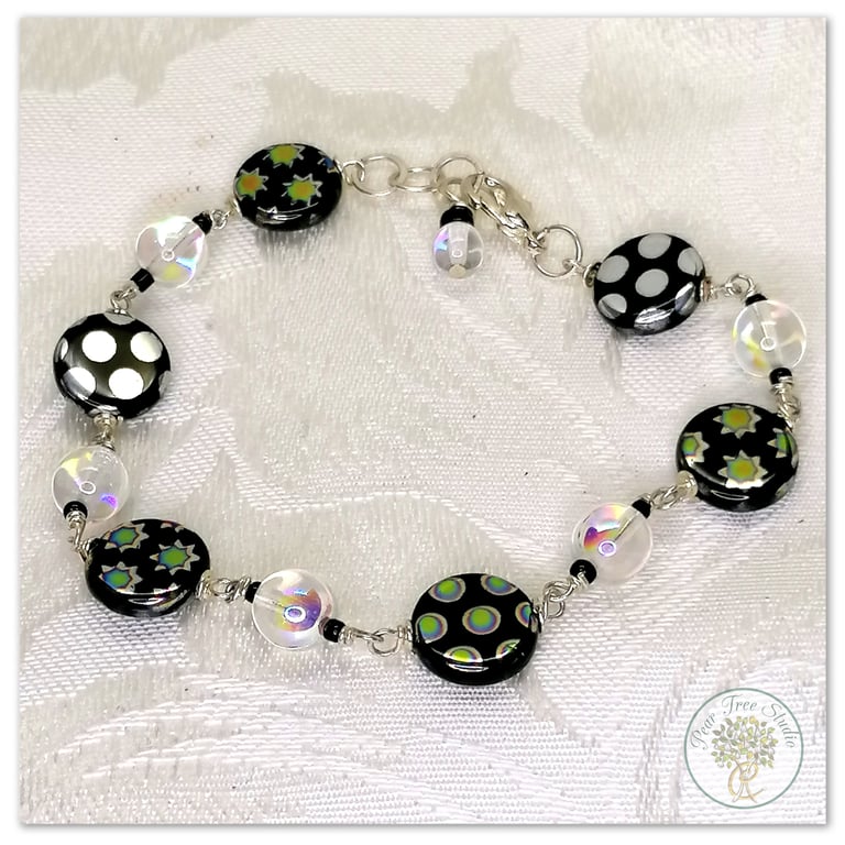 Bracelet with black and clear iridescent glass beads, silver plated.